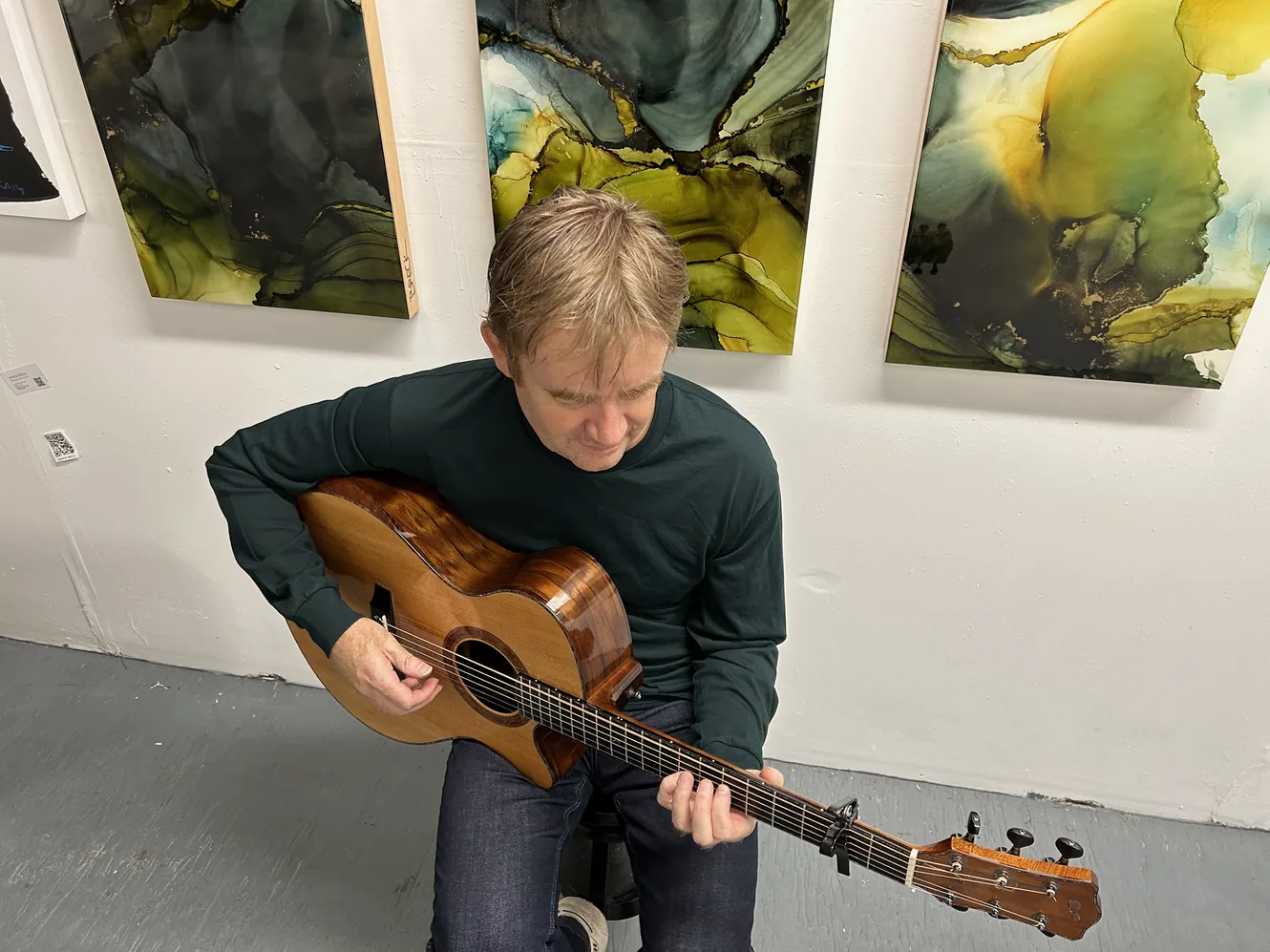 Simon Fox playing an acoustic guitar in Vancouver